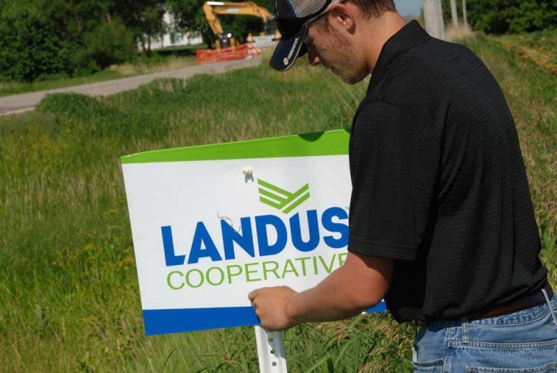 Landus Cooperative Intern putting up field signs